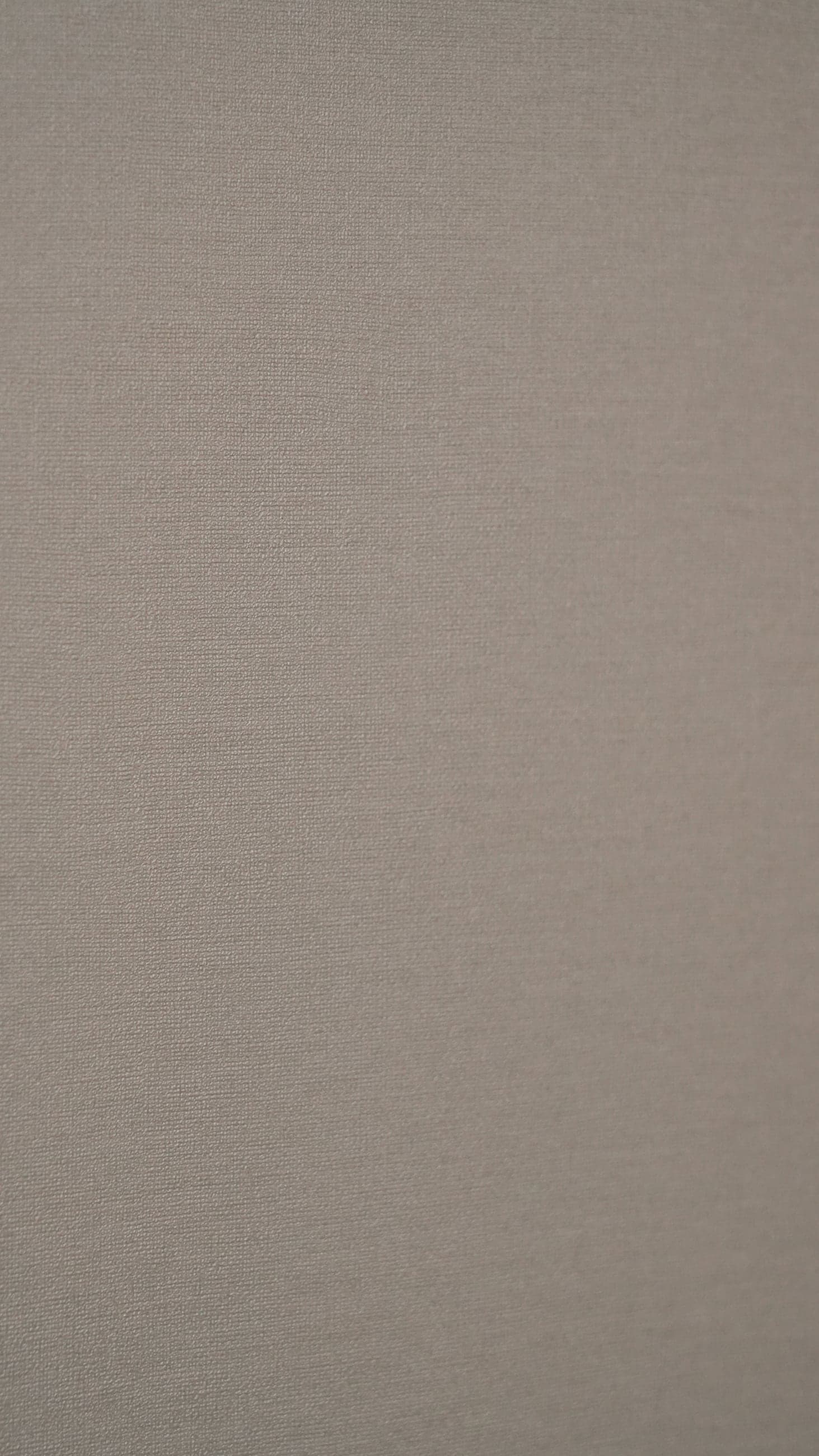 Warm sand-greige decor with a fine, regular canvas weave.